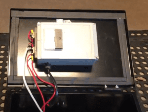 regulated power supply in aluminum case mounted on lid of steel enclosure box